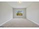 Inviting bedroom with carpet and a large window that provides excellent natural light at 6600 Wansfell Ct # 28, Douglasville, GA 30135