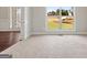 View of the foyer with wood flooring, and an elegant glass front door at 6600 Wansfell Ct # 28, Douglasville, GA 30135