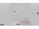 Well-lit laundry room with white walls, tile flooring, and essential hookups and storage at 6600 Wansfell Ct # 28, Douglasville, GA 30135
