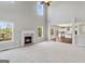 Spacious living room with fireplace, high ceilings, and large windows offering abundant natural light at 6600 Wansfell Ct # 28, Douglasville, GA 30135