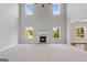 Bright living room featuring fireplace, high ceilings, and large windows allowing for natural light at 6600 Wansfell Ct # 28, Douglasville, GA 30135