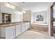 The main bathroom features double sinks, a tub, a shower, and tile floors at 6600 Wansfell Ct # 28, Douglasville, GA 30135