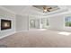 The main bedroom has a trey ceiling with fan, a fireplace and many windows at 6600 Wansfell Ct # 28, Douglasville, GA 30135