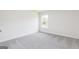 Vacant bedroom has neutral carpeting and window for natural light at 287 Limestone Circle, Conyers, GA 30013