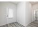 Bright entryway with a back door, light gray wood floors, and a partial view of the bathroom at 287 Limestone Circle, Conyers, GA 30013