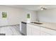 Kitchen island features stainless steel dishwasher and sink with white cabinets at 287 Limestone Circle, Conyers, GA 30013