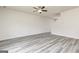 Minimalist living room showcasing light gray wood floors, ceiling fan, and staircase at 287 Limestone Circle, Conyers, GA 30013