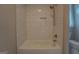Clean bathroom featuring a subway tiled shower with built-in niche and modern fixtures at 5118 N Pratt St, Covington, GA 30014