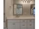 Bathroom vanity with double sinks, framed mirrors, and contemporary lighting fixtures at 5118 N Pratt St, Covington, GA 30014