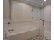 Bright bathroom with a tub and shower, white subway tiles, and patterned floor at 5118 N Pratt St, Covington, GA 30014