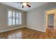 Bedroom featuring hardwood floors, neutral paint, ceiling fan, and plantation shutters at 5118 N Pratt St, Covington, GA 30014