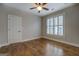 Bedroom featuring hardwood floors, neutral paint, ceiling fan and plantation shutters at 5118 N Pratt St, Covington, GA 30014