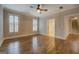 Bright bedroom with hardwood floors, crown molding, and two windows with plantation shutters at 5118 N Pratt St, Covington, GA 30014