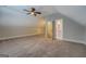 Open bedroom offers ample space, soft carpeting, a ceiling fan, and leads to the en suite bathroom at 5118 N Pratt St, Covington, GA 30014