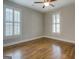 Bedroom featuring hardwood floors, neutral paint, and plantation shutters at 5118 N Pratt St, Covington, GA 30014