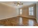 Spacious bedroom with hardwood floors, crown molding, and natural light from two windows at 5118 N Pratt St, Covington, GA 30014