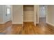 Entry with a view of hardwood floors, open closet, and neutral paint at 5118 N Pratt St, Covington, GA 30014