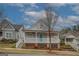 Charming two-story home featuring a spacious front porch with blue door and well-maintained landscaping at 5118 N Pratt St, Covington, GA 30014