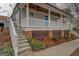 Beautiful home exterior featuring a welcoming front porch, brick foundation, and landscaped front yard at 5118 N Pratt St, Covington, GA 30014