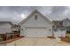 Detached two-car garage with white door and concrete driveway on a cloudy day at 5118 N Pratt St, Covington, GA 30014