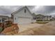 Side view of a detached two-car garage with long driveway on a cloudy day at 5118 N Pratt St, Covington, GA 30014