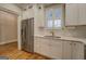 Updated kitchen features stainless steel appliances, white cabinets and quartz countertops at 5118 N Pratt St, Covington, GA 30014