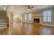 Elegant living space showcasing hardwood floors, a brick fireplace, and abundant natural light at 5118 N Pratt St, Covington, GA 30014