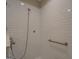 Bright shower with grab bar and white subway tile at 5118 N Pratt St, Covington, GA 30014