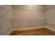 Walk-in closet with white wire shelving and hardwood floors at 5118 N Pratt St, Covington, GA 30014