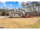 Backyard view of the house, including a large lawn and a wooden deck with outdoor seating at 115 Wellborn Chase, Fayetteville, GA 30215