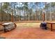 Spacious deck overlooking the backyard, with built-in grill and a wooded perimeter at 115 Wellborn Chase, Fayetteville, GA 30215