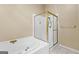 Bathroom features a gold-trimmed shower, soaking tub, and neutral walls at 115 Wellborn Chase, Fayetteville, GA 30215