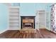 Bedroom featuring hardwood floors, a stone fireplace, built-in bookshelves, and french doors at 115 Wellborn Chase, Fayetteville, GA 30215