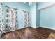 Bright bedroom with hardwood floors, fresh paint, and stylish black and white curtains at 115 Wellborn Chase, Fayetteville, GA 30215