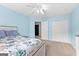 Bright bedroom featuring blue walls, carpeted floors, closet, and a ceiling fan at 115 Wellborn Chase, Fayetteville, GA 30215