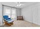 Bright bedroom featuring a crib, plush chair with ottoman, and neutral carpet flooring at 115 Wellborn Chase, Fayetteville, GA 30215