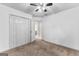Bright, carpeted bedroom with closet and doorway to an adjoining room at 115 Wellborn Chase, Fayetteville, GA 30215