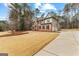 Traditional brick home with a manicured lawn and mature trees, complemented by a spacious driveway at 115 Wellborn Chase, Fayetteville, GA 30215