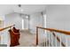 Upstairs hallway boasts neutral walls, carpet, and beautiful woodwork at 115 Wellborn Chase, Fayetteville, GA 30215