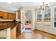 Kitchen and eat-in area featuring hardwood floors and access to the outdoor fireplace at 115 Wellborn Chase, Fayetteville, GA 30215