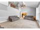 Spacious living room features neutral carpet and paint, with a view into the kitchen and upstairs hallway at 115 Wellborn Chase, Fayetteville, GA 30215