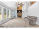 Spacious living room showcasing a stone fireplace, high ceilings, and natural light from large windows at 115 Wellborn Chase, Fayetteville, GA 30215
