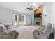 Bright living room features a stone fireplace, vaulted ceiling, and large windows for ample natural light at 115 Wellborn Chase, Fayetteville, GA 30215