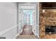 View through french doors to a bright room with hardwood floors and black & white patterned curtains at 115 Wellborn Chase, Fayetteville, GA 30215