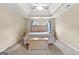 Well-lit main bedroom with carpet, neutral walls, and a wooden accent chest at 115 Wellborn Chase, Fayetteville, GA 30215