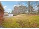 Large fenced backyard with a storage shed and a concrete patio, perfect for outdoor enjoyment at 979 Walnut Creek Ln, Jonesboro, GA 30238