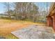 Backyard concrete patio, lawn, and fence with a view of the home's exterior, ideal for outdoor living at 979 Walnut Creek Ln, Jonesboro, GA 30238