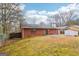 Fenced backyard featuring a concrete patio, lawn area, and a brick house exterior with a chimney at 979 Walnut Creek Ln, Jonesboro, GA 30238