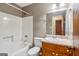 Cozy bathroom features a shower-tub combination and wood vanity at 979 Walnut Creek Ln, Jonesboro, GA 30238