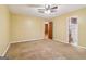Bedroom featuring ceiling fan, plush carpet, and access to ensuite bathroom at 979 Walnut Creek Ln, Jonesboro, GA 30238